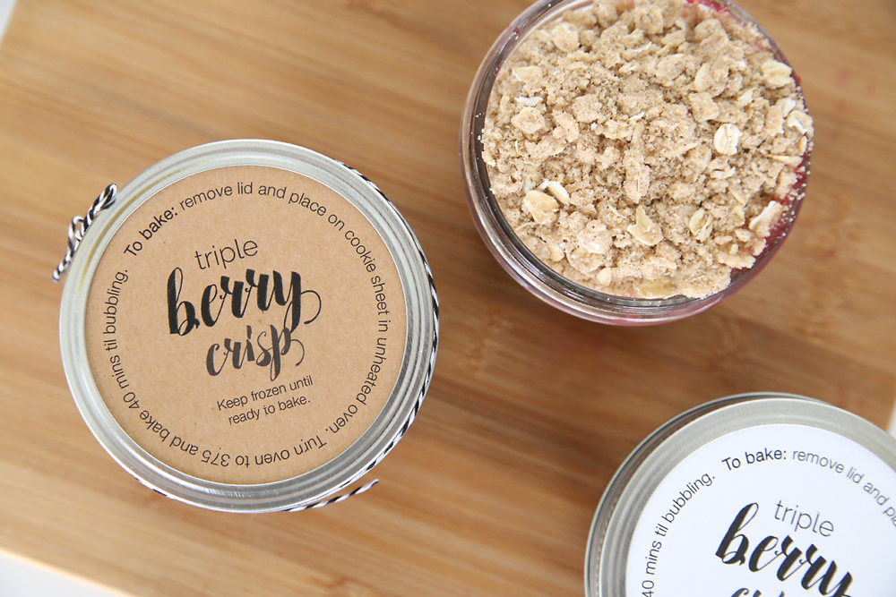berries and oat crumble topping layered in small mason jars, with lid and printable tags