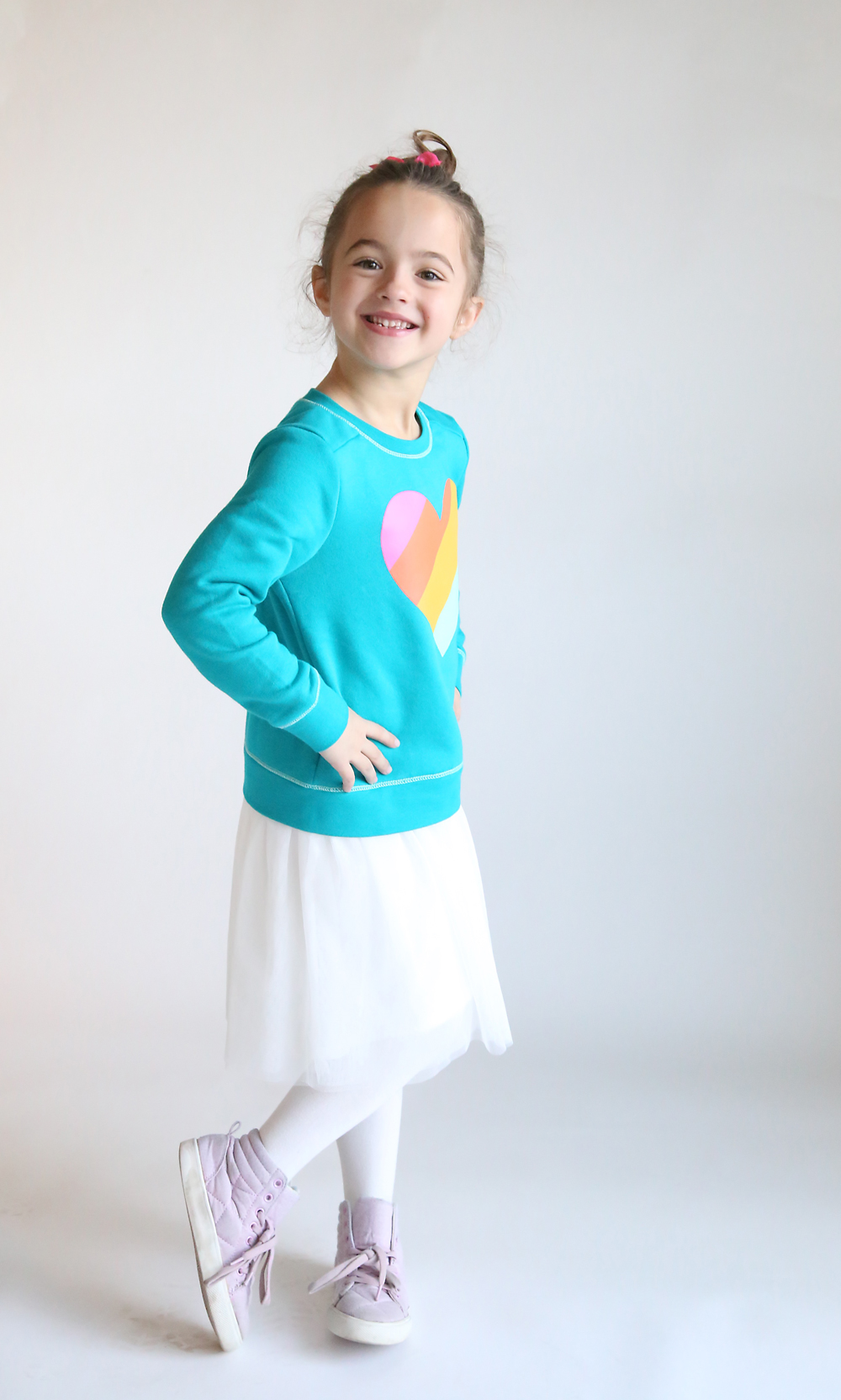 Photo of a girl wearing a dress made by sewing a tulle skirt onto a purchased sweatshirt