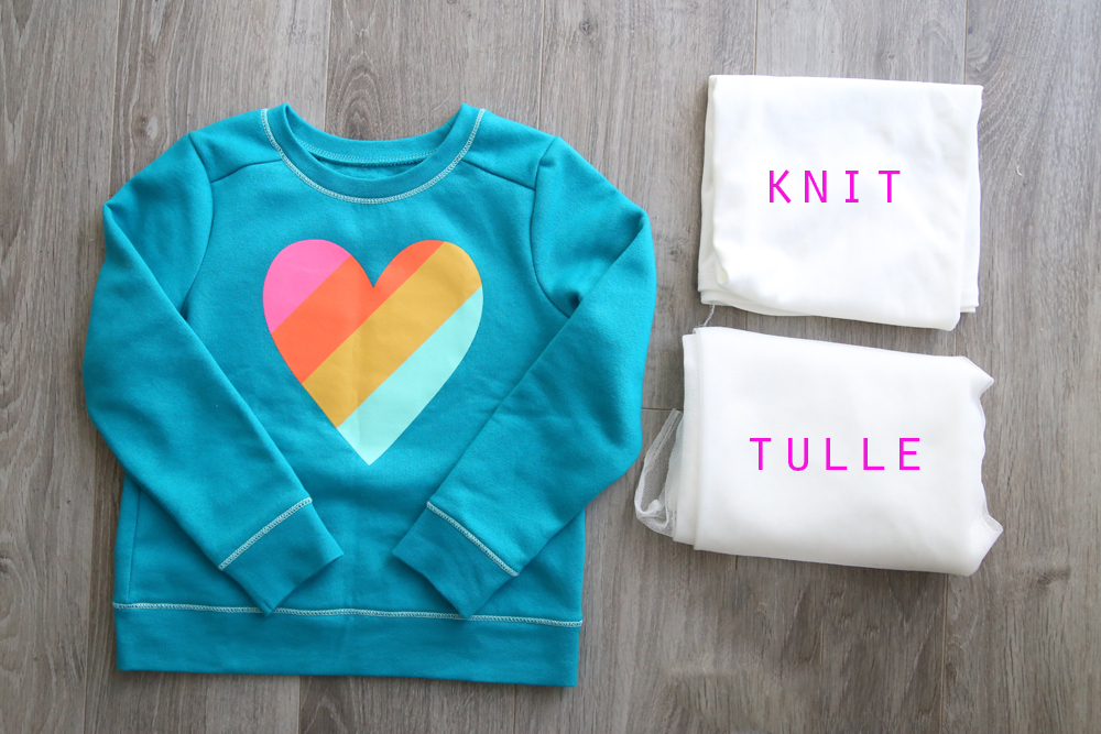 Turquoise sweatshirt with heart on it; white knit fabric and white tulle fabric