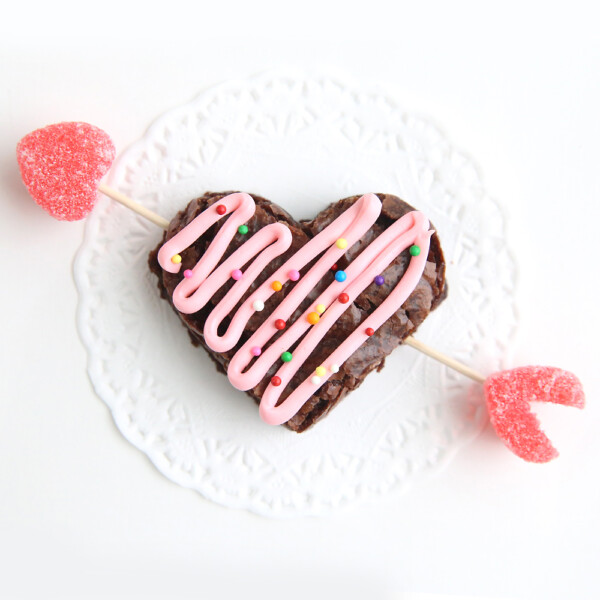 A heart brownie with an arrow through it made from toothpicks and jelly hearts
