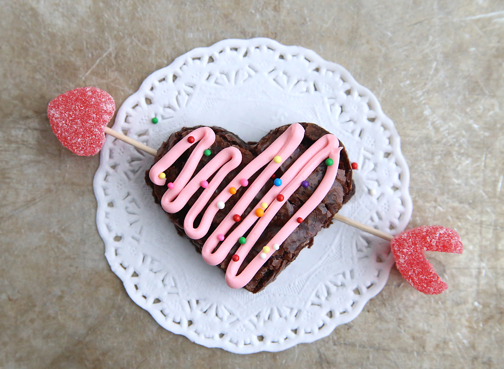 A heart brownie with an arrow through it made from toothpicks and jelly hearts