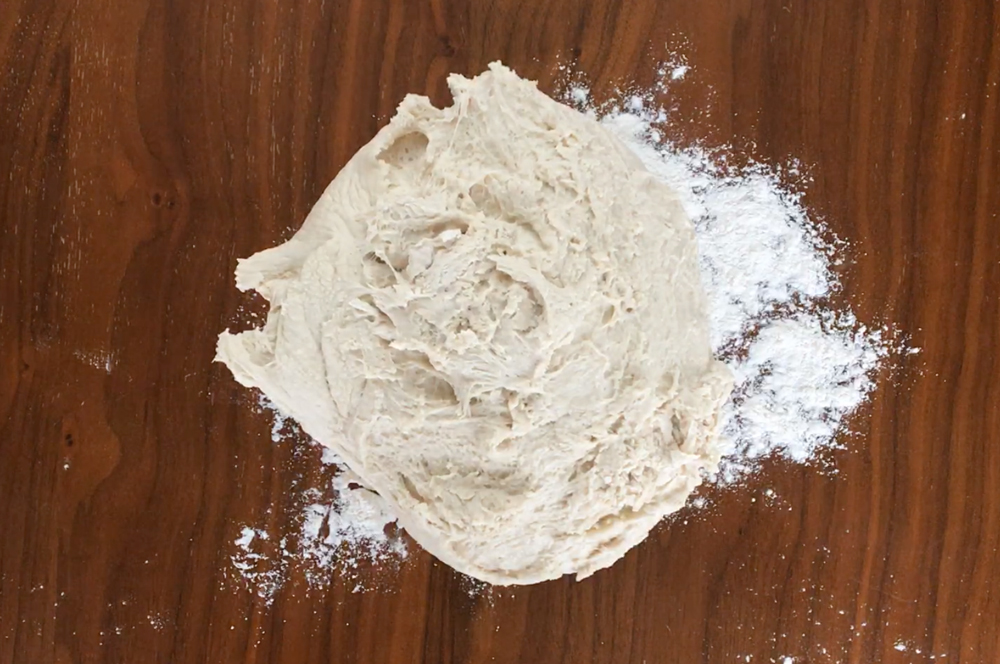 A ball of bread dough on a floured table