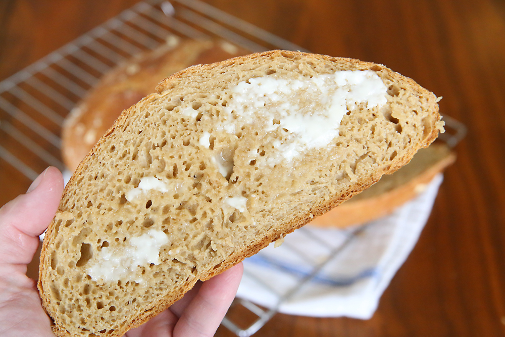 A piece of whole wheat bread spread with butter