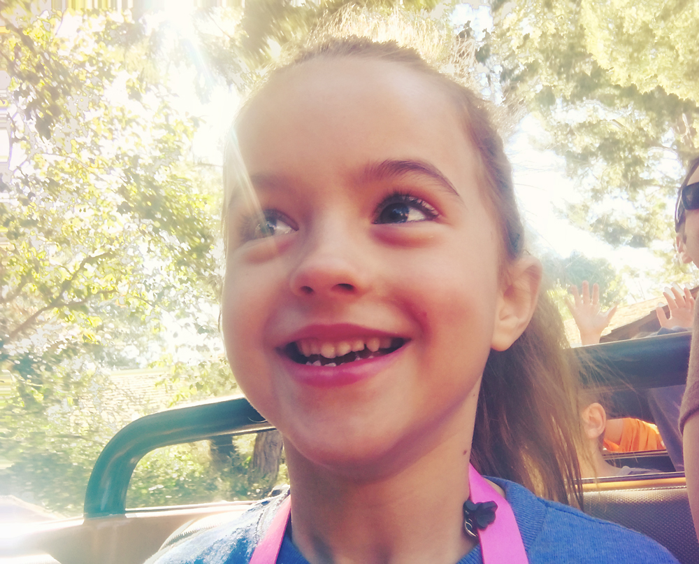 A little girl riding a roller coaster