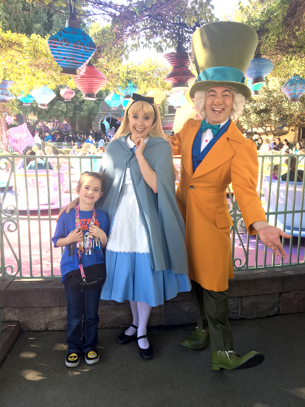 Girl posing with Disney characters, Alice and the Mad Hatter
