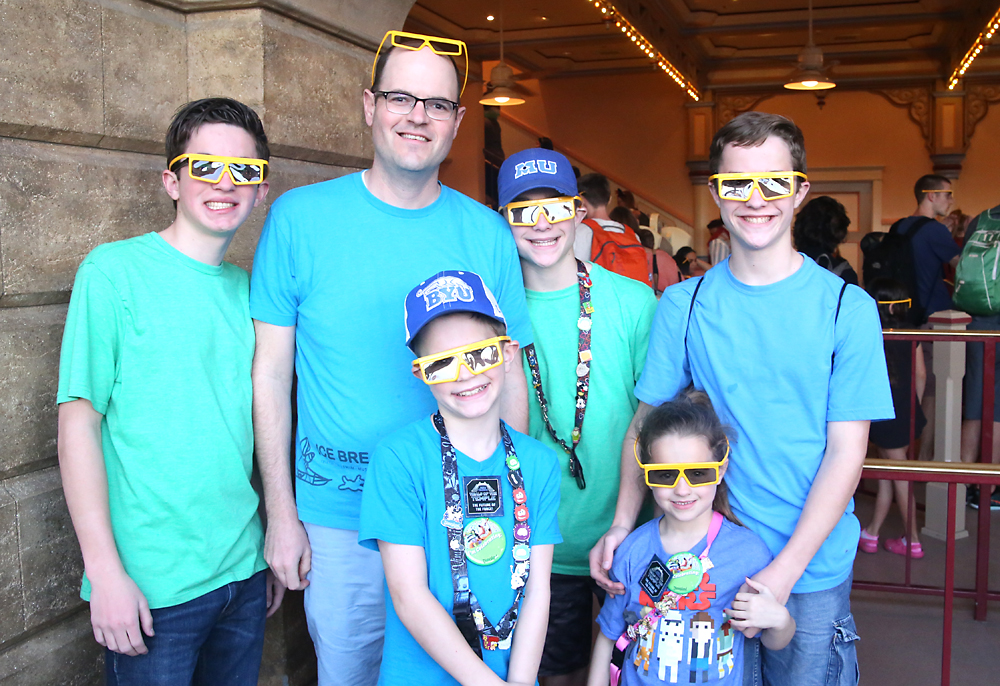 A group of people posing for the camera wearing 3D glasses
