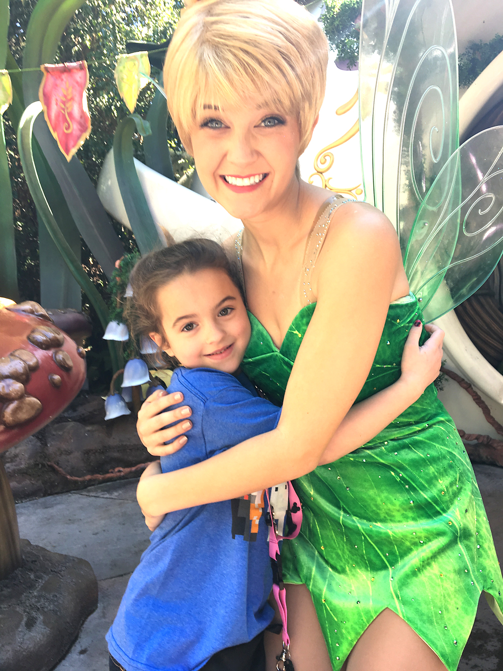 A girl posing for a picture with Tinkerbell
