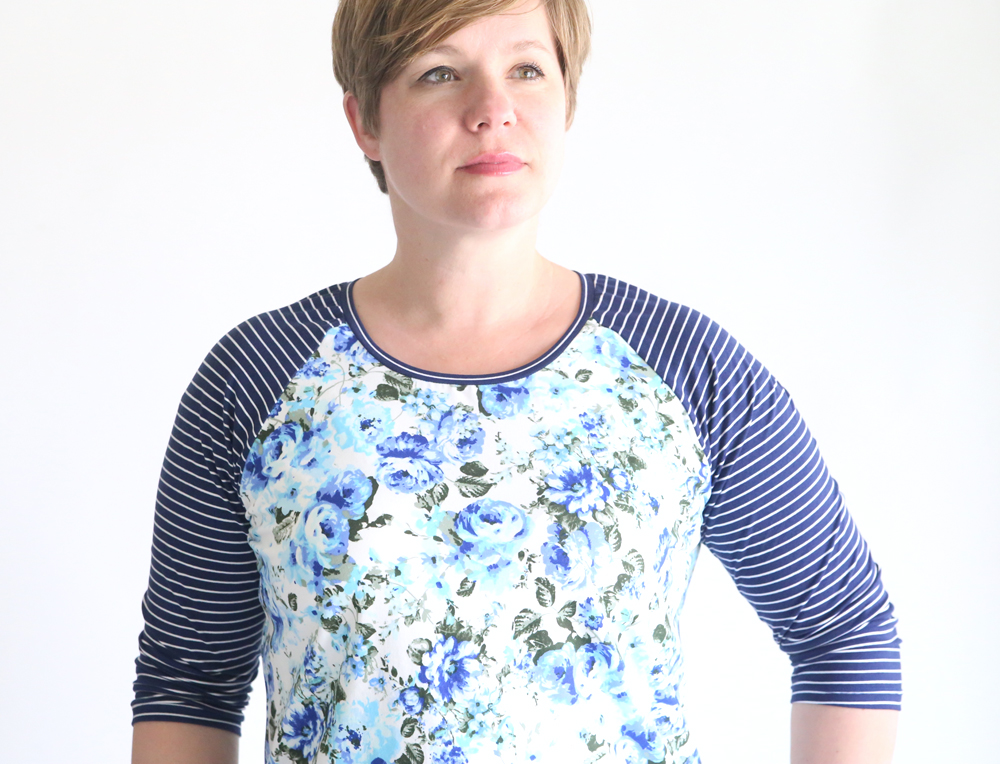 A woman wearing a floral shirt made from a raglan t-shirt sewing pattern