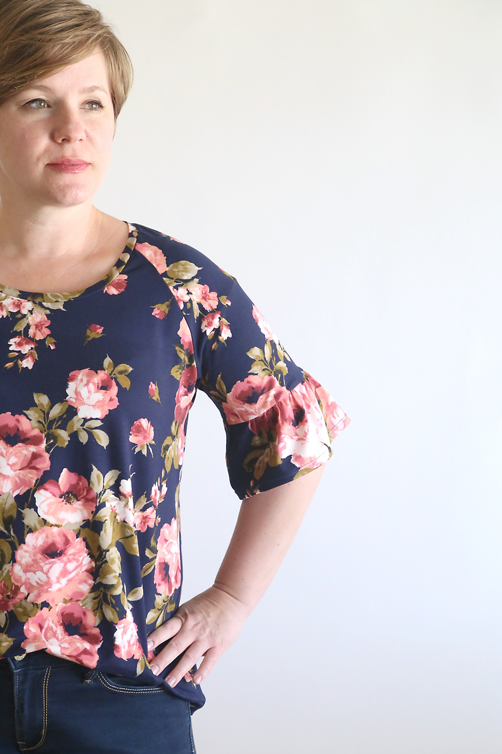 A close up of a t-shirt sleeve with a ruffle at the hem