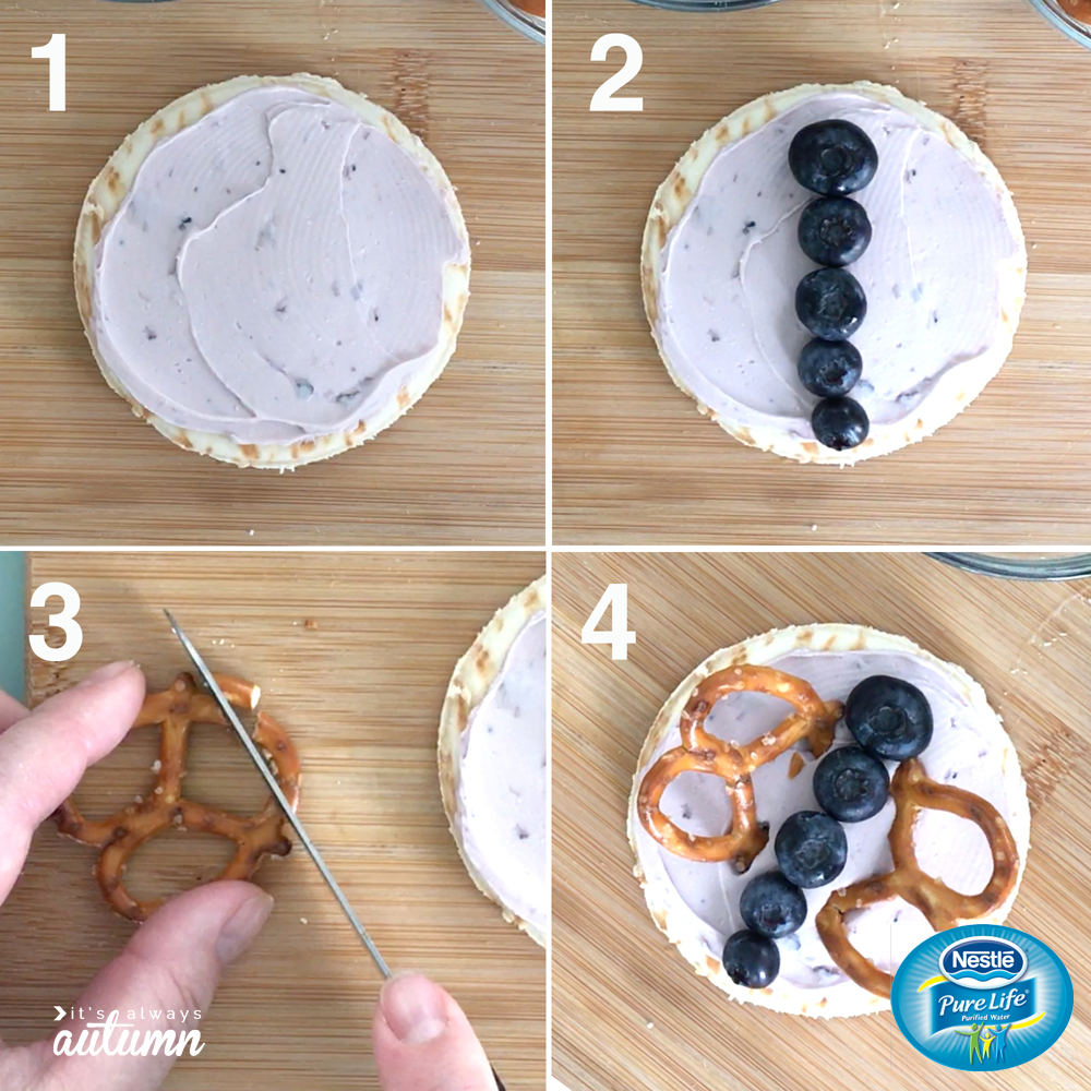 Steps for assembling butterfly snack: pita circle, cream cheese, blueberries for body, pretzels for wings
