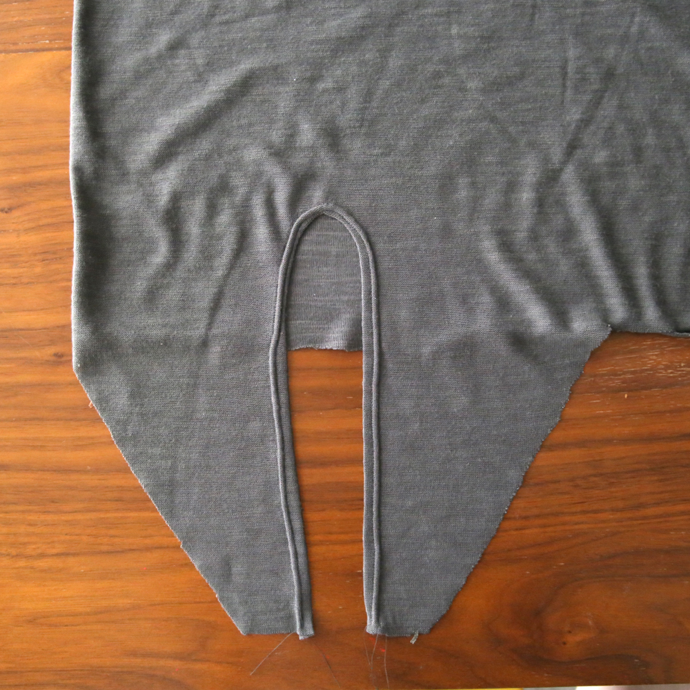Tie front portion with curved edge hemmed