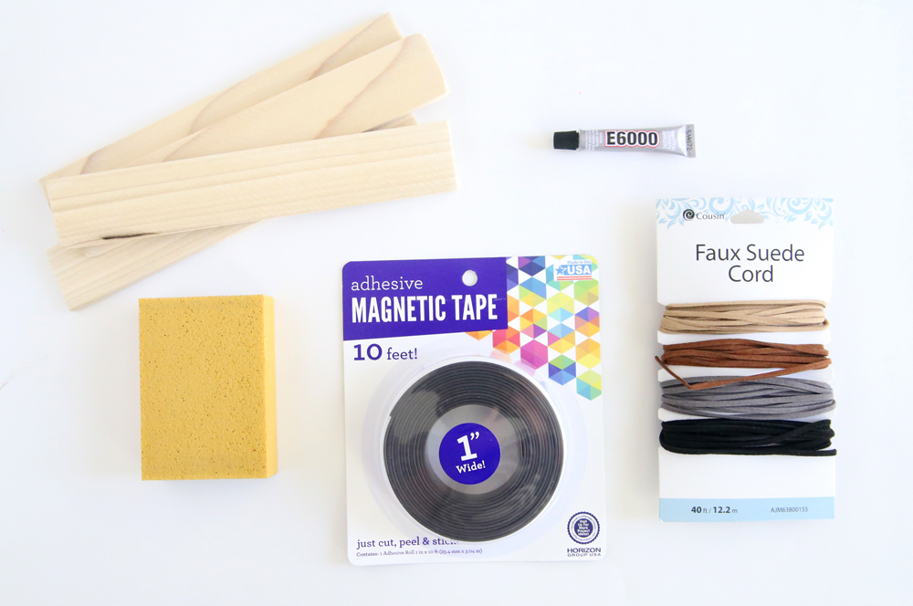 DIY frame supplies: wood slats, sanding block, magnetic tape, e6000 adhesive, faux leather cording