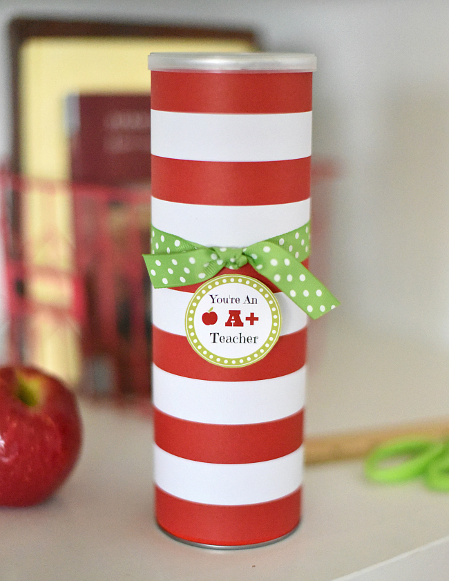 Pringles can covered in striped red and white paper with a tag for a teacher