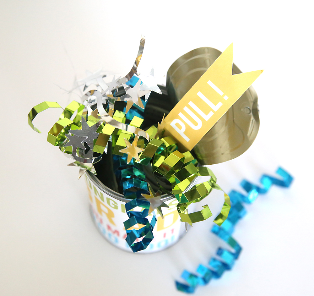 Cash in a can gift: open pop top tin can with ribbons and a tag that says pull