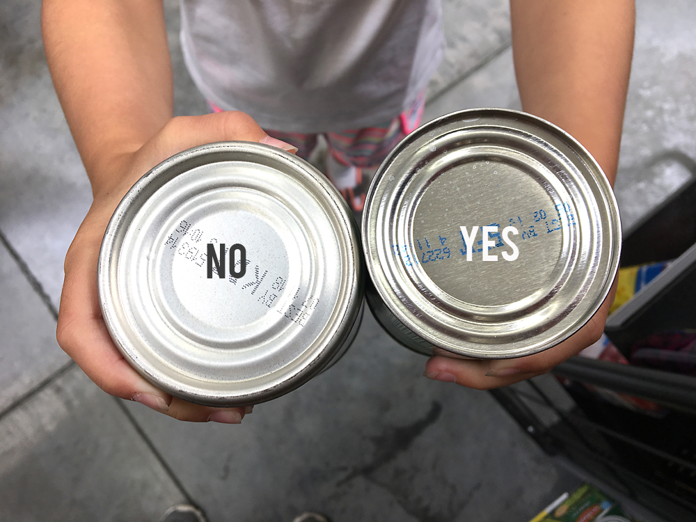 Bottom of two cans, one can be opened with a can opener