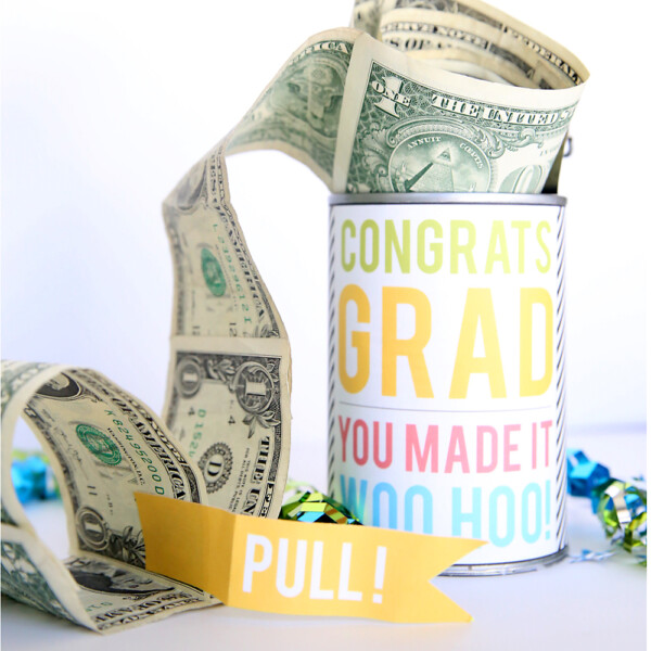 Tin can decorated with congrats grad wrapper, with roll of dollar bills coming out of it