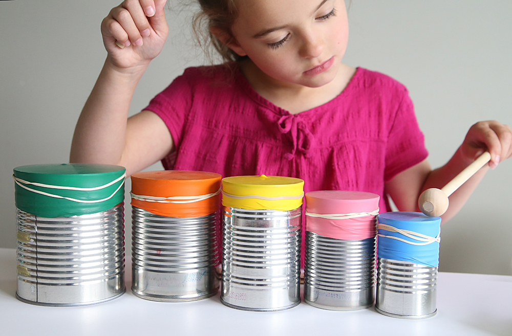 Girl playing DIY drumset