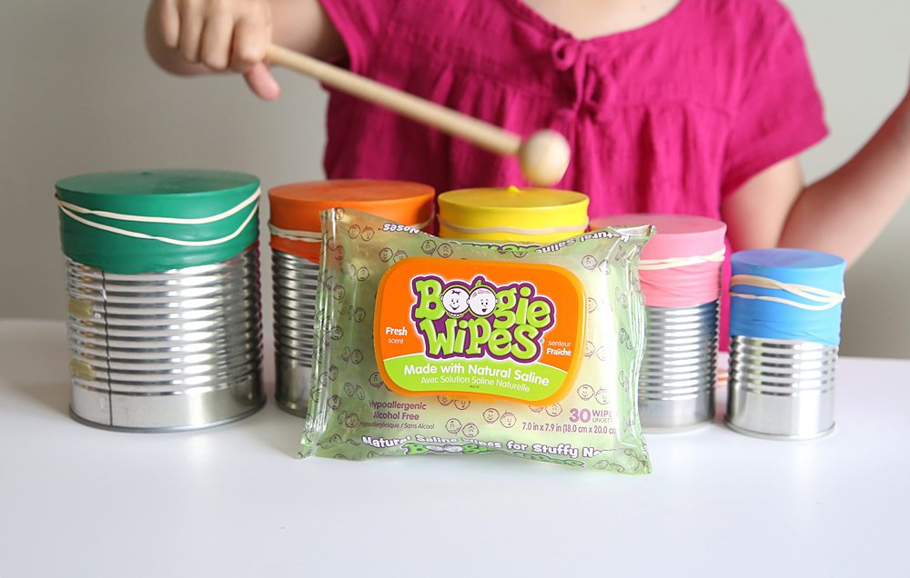 Girl playing DIY drumset and package of boogie wipes