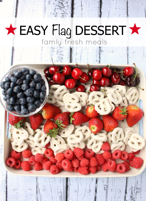 Berries and white chocolate pretzels arranged in a flag shape for Fourth of July