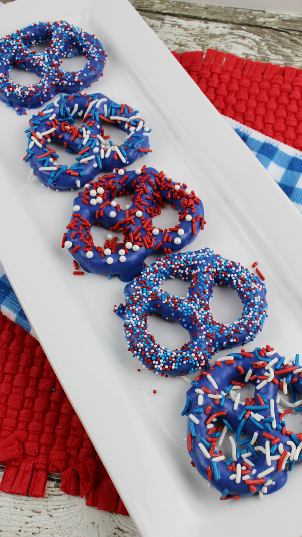 Pretzels covered in blue candy coating and sprinkles