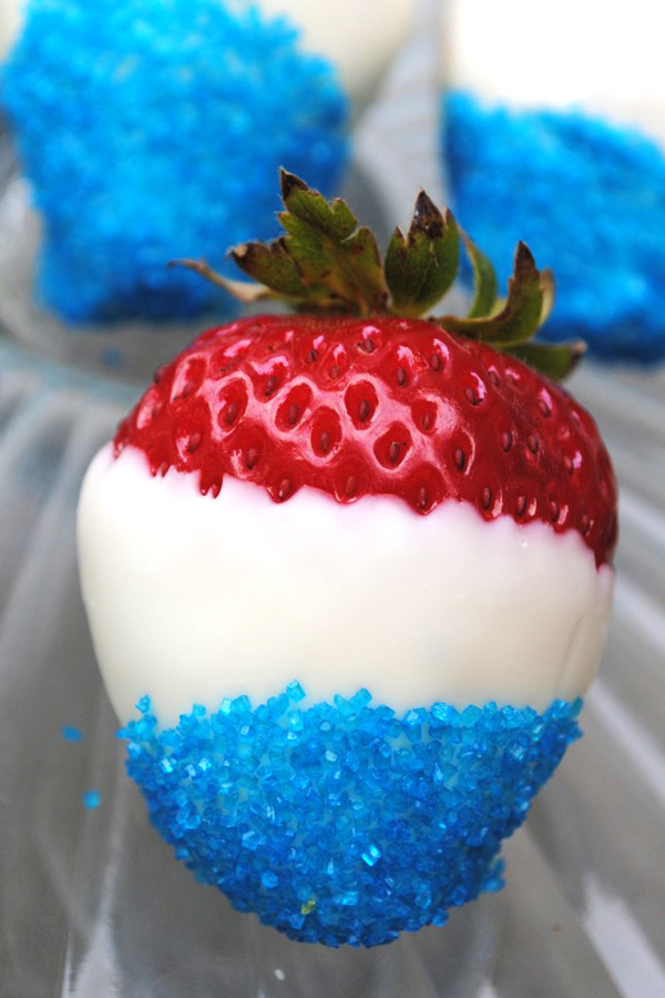 Strawberry dipped in white chocolate with blue sprinkles