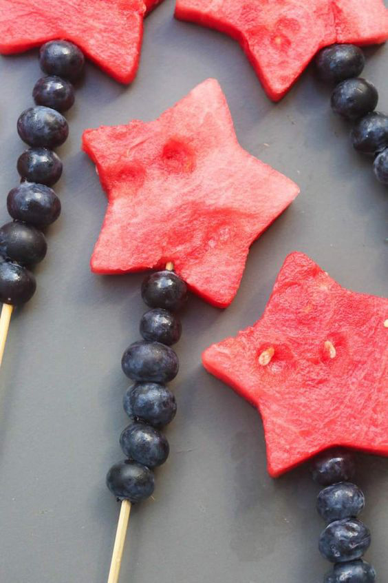 Watermelon cut in star shape on kabobs with blueberries