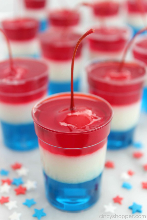 Red, white and blue jello cups with a cherry on top
