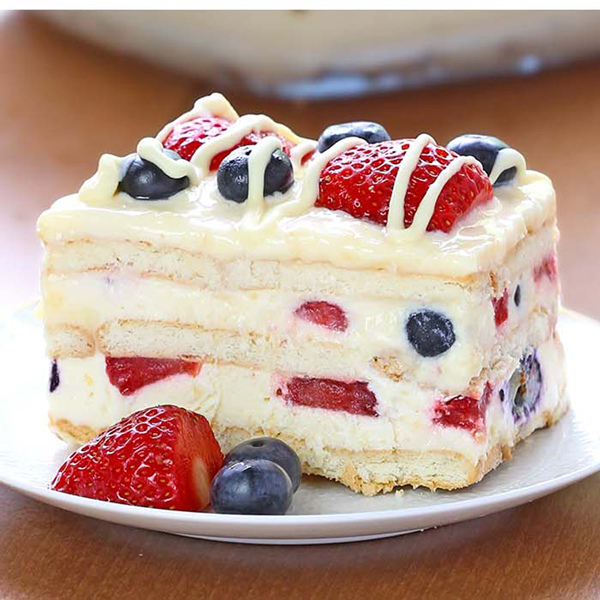 Layered summer berry icebox cake on a plate