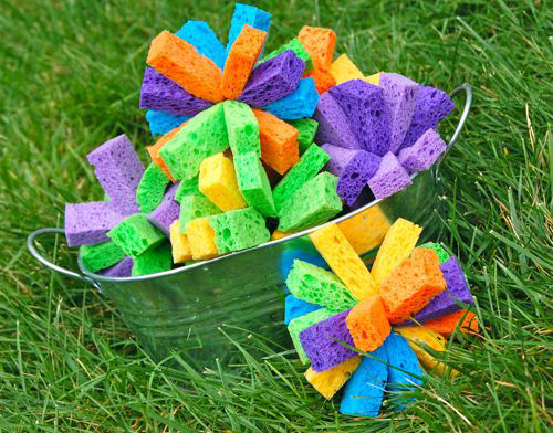 Water bombs made from sponges in a metal bowl on the grass