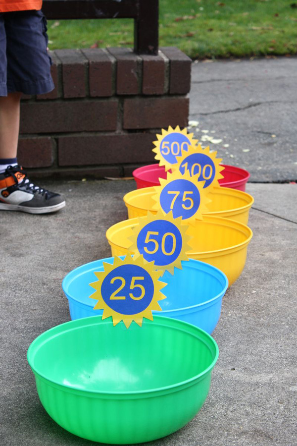 A row of bowls set up for water balloons to be thrown into, with the closest bowl earning 25 points and the furthest bowl earning 500 points