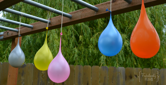 Water balloons hanging from a wood playset
