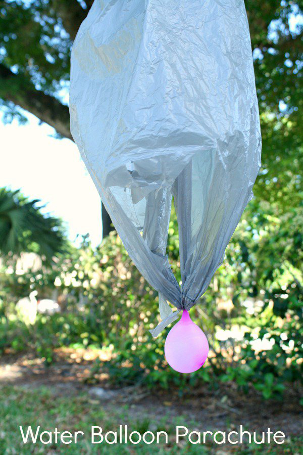 A water balloon with a plastic sack above it as a parachute