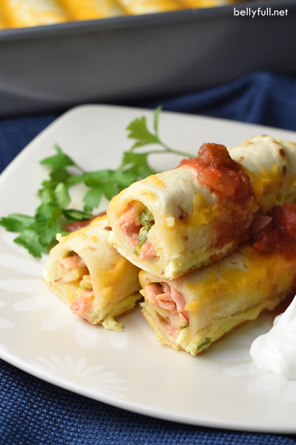 Make ahead breakfast enchiladas on a plate with salsa