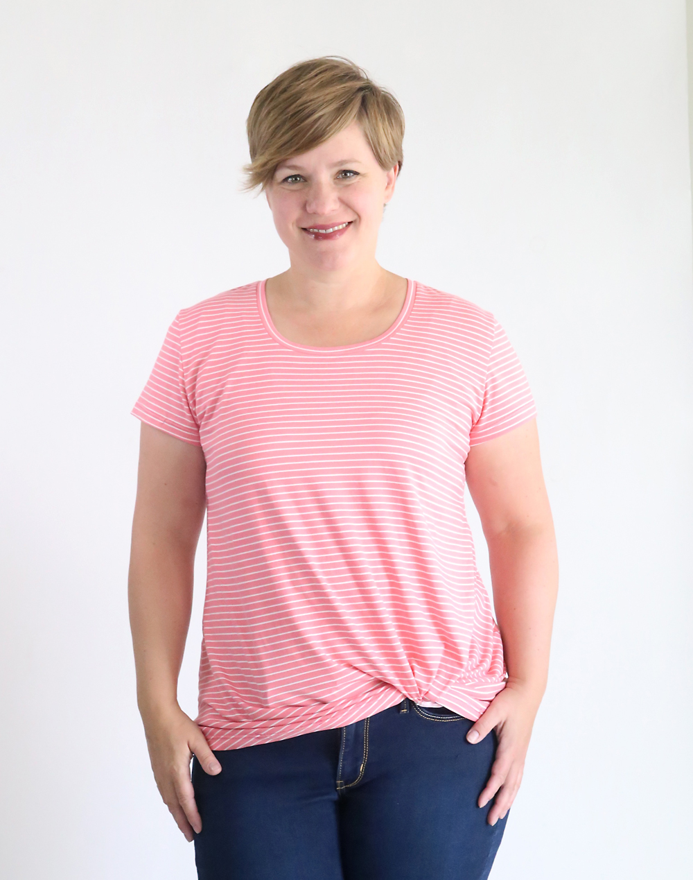 Woman wearing pink t-shirt made from the twist knot tee sewing pattern