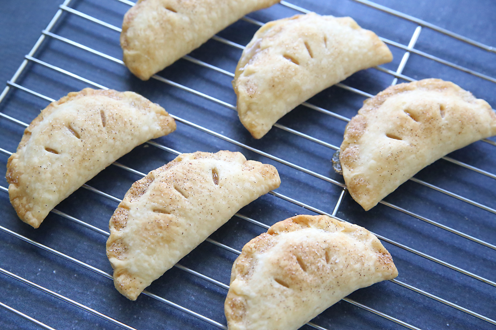 Baked apple hand pies on a cooling rack