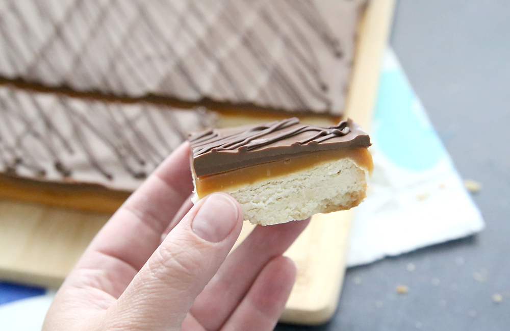 Dessert bar with shortbread base, caramel layer, and chocolate layer on top.