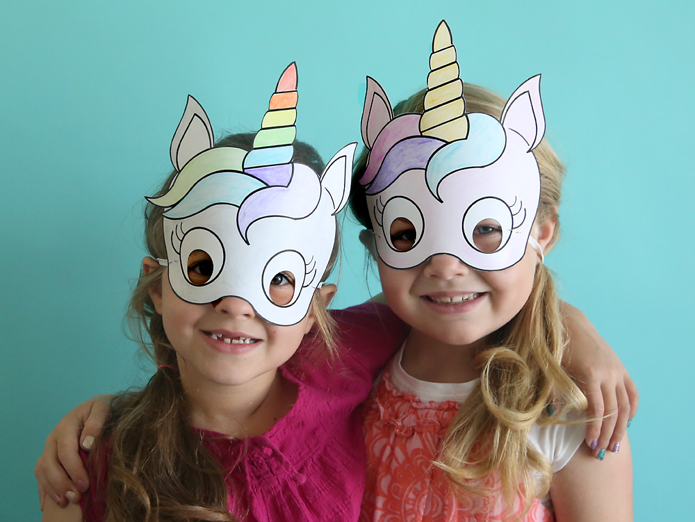 Girls wearing paper unicorn masks