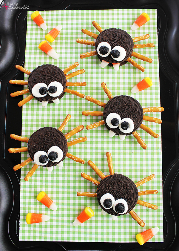 oreos with candy eyes and pretzel stick legs to make spider cookies