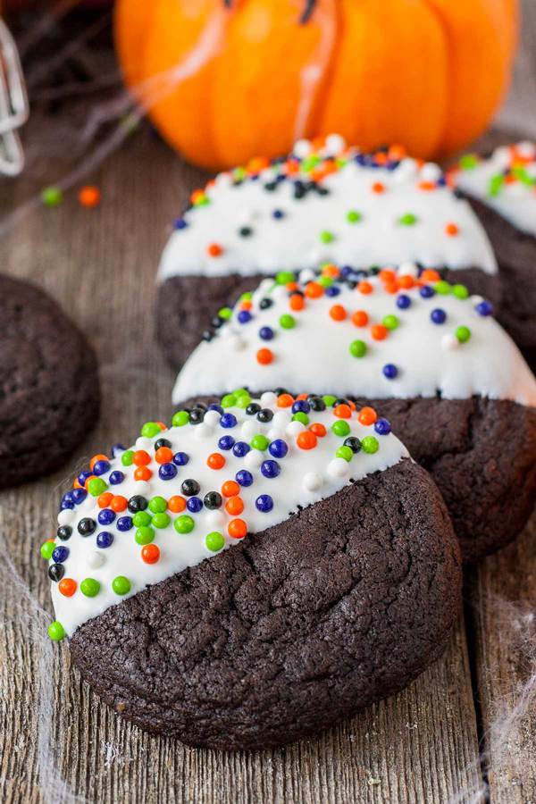 Chocolate cookies dipped in white chocolate and sprinkles