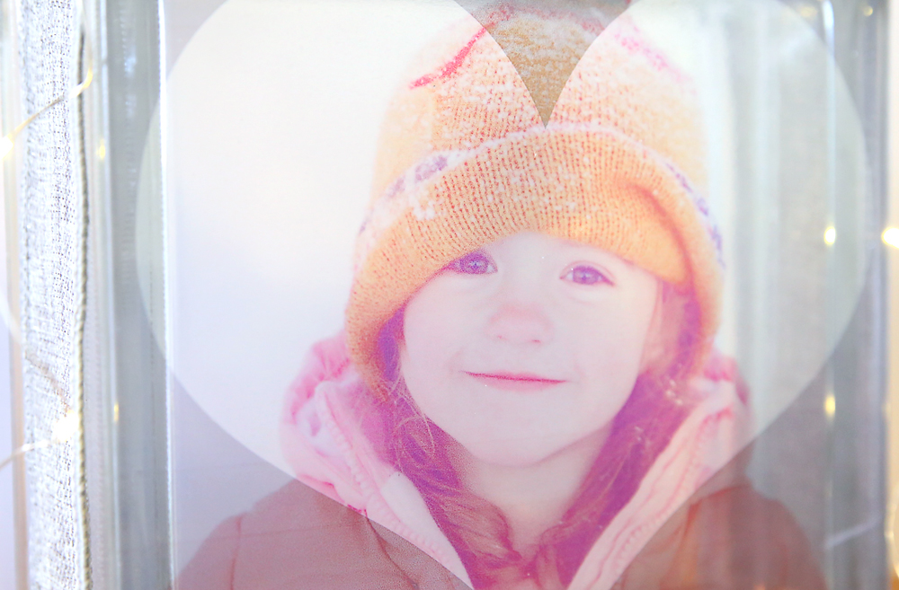 Photo of a little girl wearing snow clothes