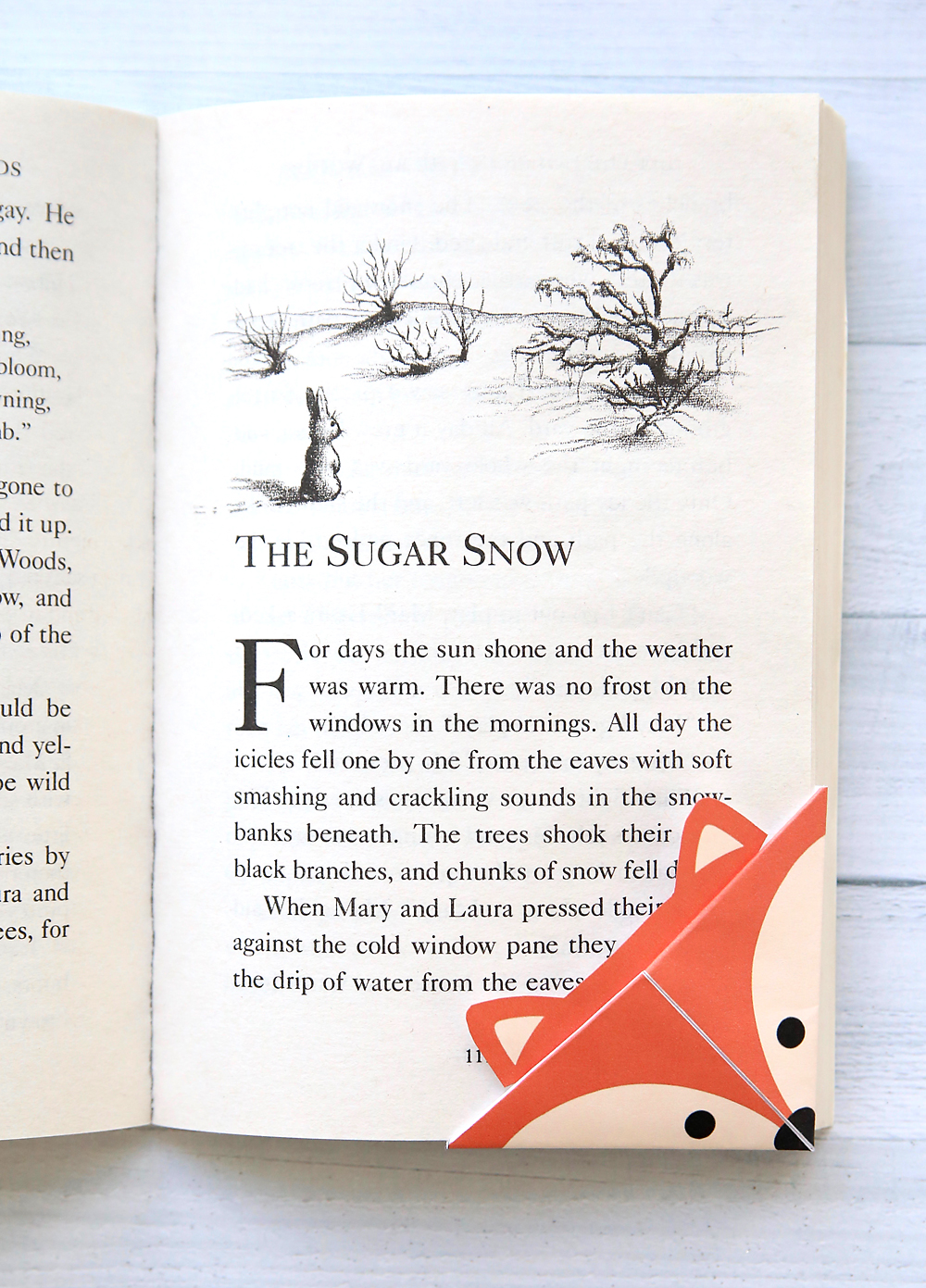 A folded corner bookmark on a book (fox)