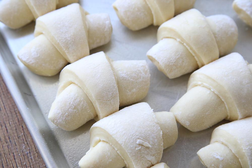 Unbaked crescent rolls on a baking sheet