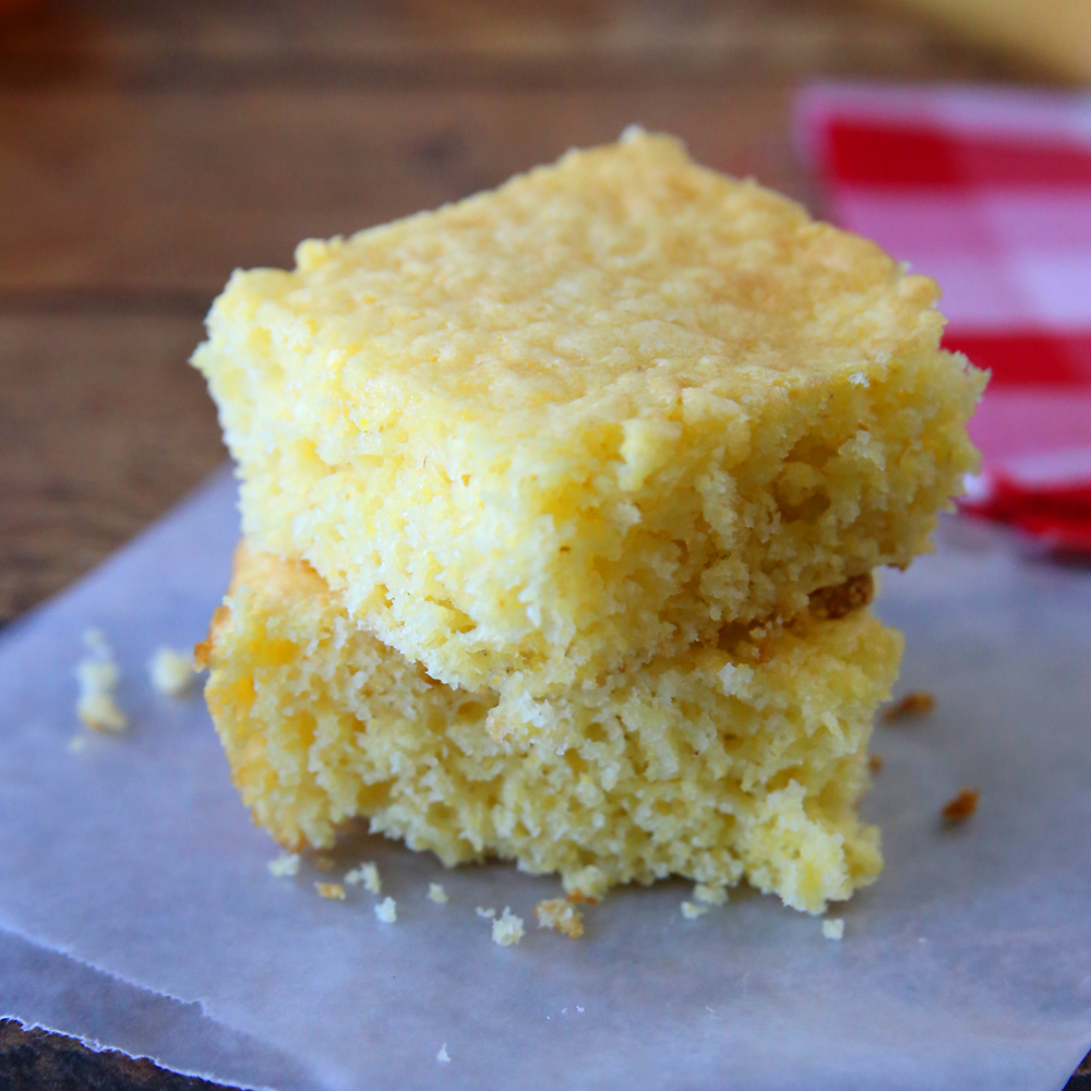 Two pieces of Jiffy cornbread stacked on a plate