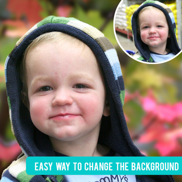 A little boy smiling at the camera with leaves in the background