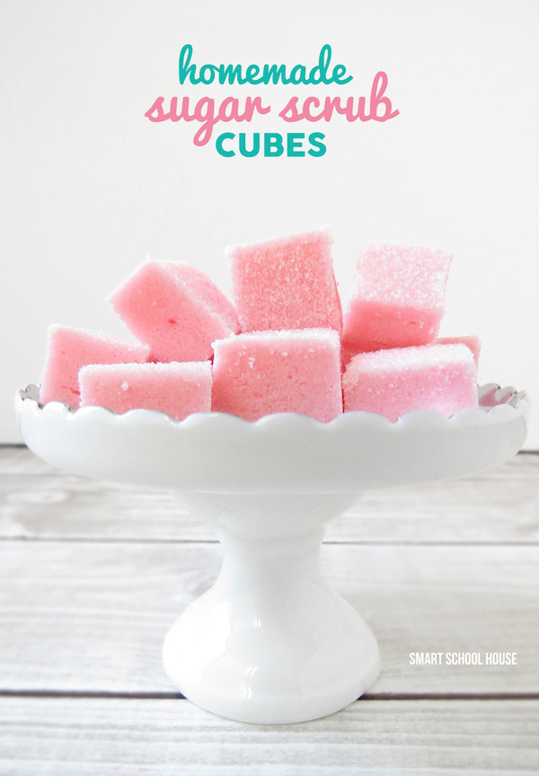 Pink homemade sugar scrub cubes on a white dish
