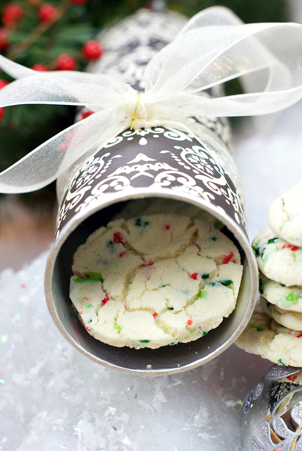 Chip can decorated with Christmas paper and ribbon with Christmas cookies inside