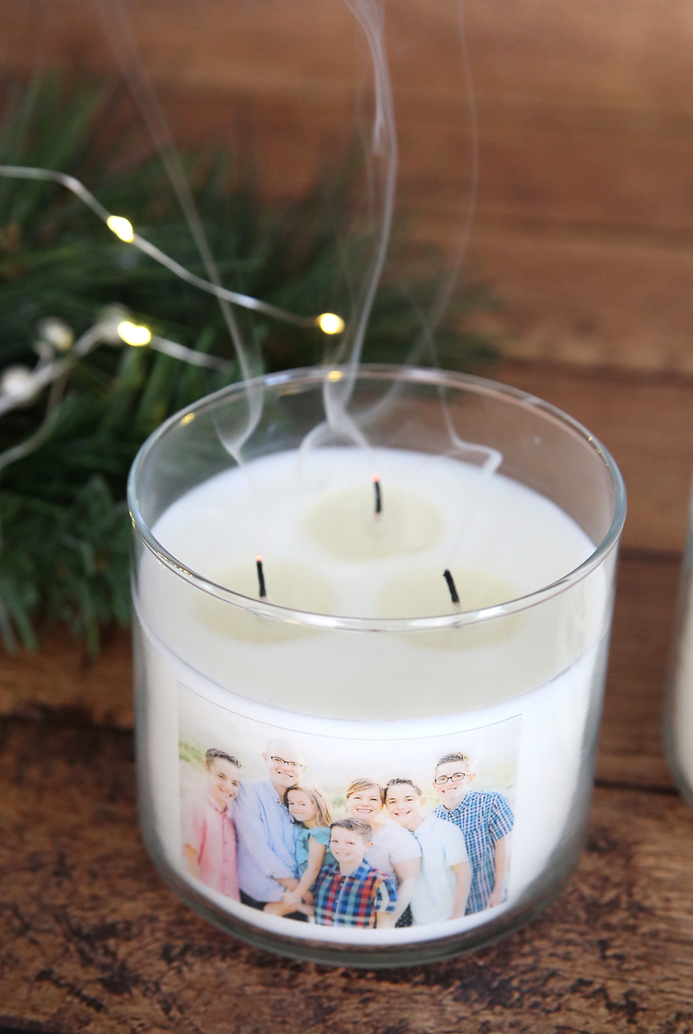 Personalized photo candle that has just been blown out; smoke coming from wicks