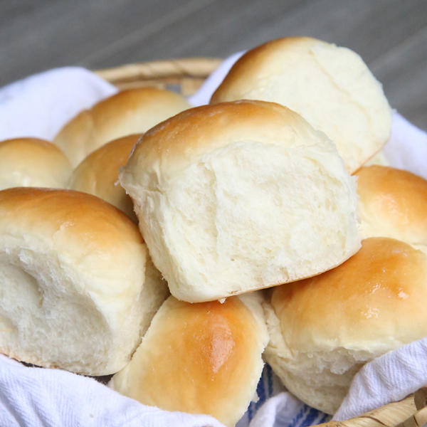 Homemade dinner rolls stacked in a basket