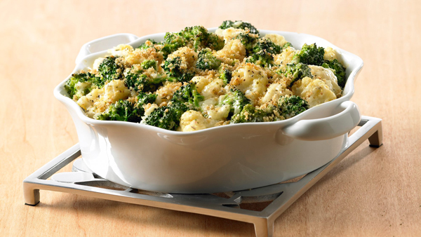 A bowl of broccoli cauliflower casserole that can be made ahead of time