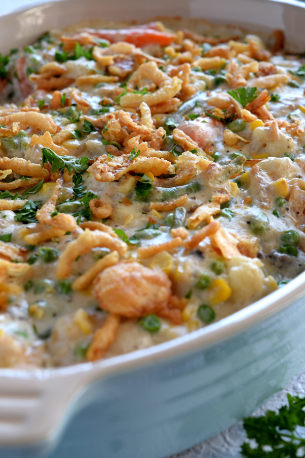 Close up of food: make ahead Thanksgiving vegetable casserole with french fried onions on top